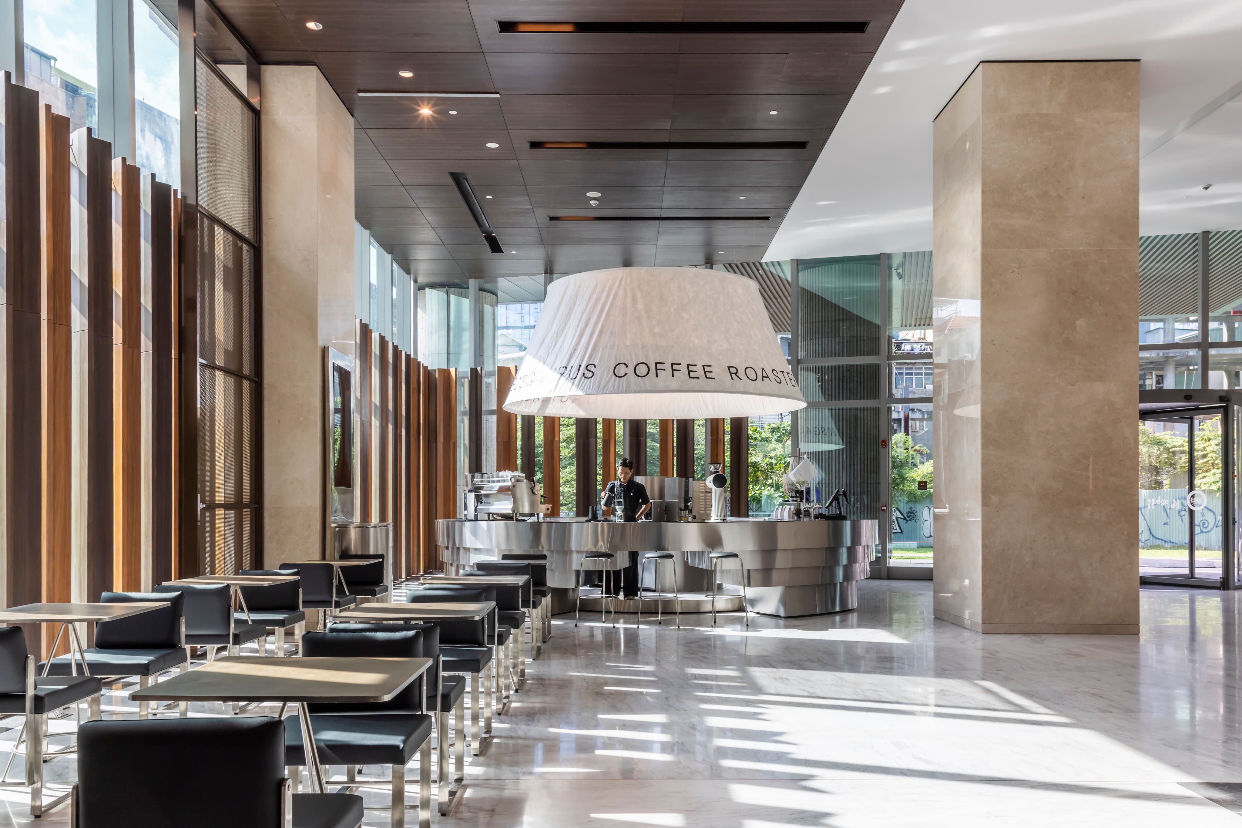 Spacious modern lobby with a prominent reception desk and marble features